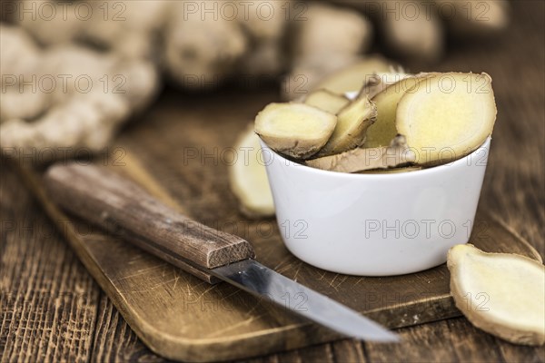 Healthy Raw Ginger on a wooden table as detailed close-up shot (selective focus)