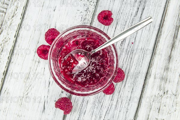 Fresh made Raspberry Jam on a vintage background as detailed close-up shot