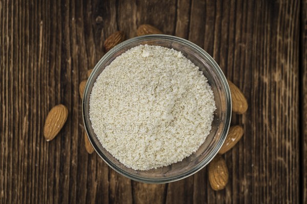 Wooden table with Almond Flour (detailed close-up shot, selective focus)