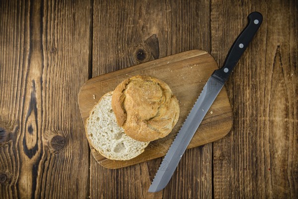 Fresh made German Buns on an old and rustic wooden table, selective focus, close-up shot
