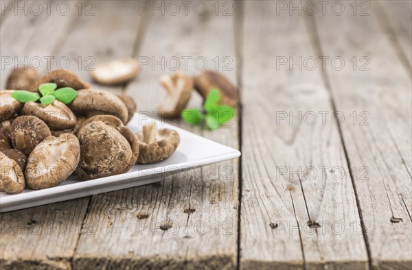 Shiitake mushrooms on a vintage background as detailed close-up shot, selective focus