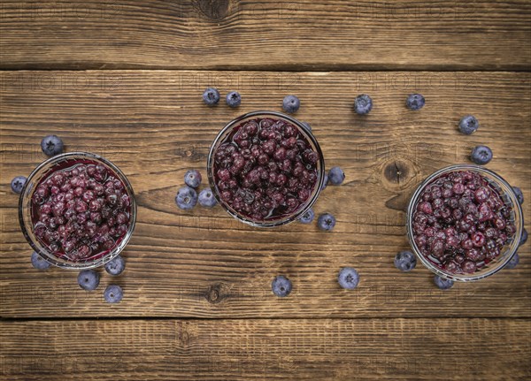 Fresh made Blueberries (preserved) on an old and rustic wooden table, selective focus, close-up