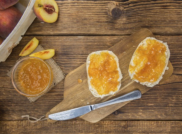 Portion of fresh Peach Jam close-up shot, selective focus