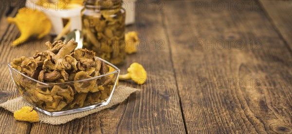 Canned chanterelles on a vintage background as detailed close-up shot, selective focus