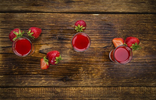 Some homemade Strawberry liqueur as detailed close-up shot, selective focus