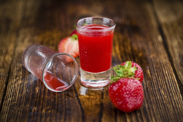 Homemade Strawberry liqueur on vintage background selective focus, close-up shot