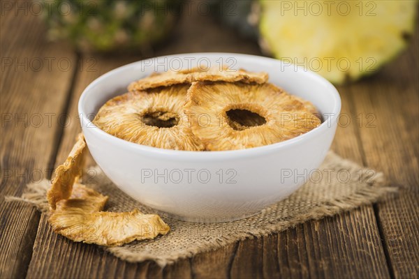 Dried Pineapple Rings on a vintage background as detailed close-up shot, selective focus