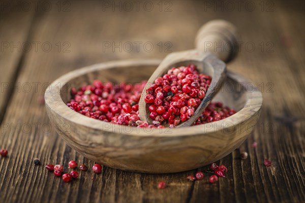 Pink Peppercorns on a vintage background as detailed close-up shot, selective focus