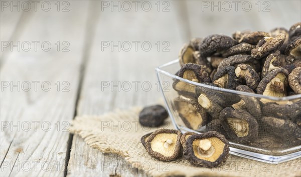 Fresh made Shiitake mushrooms (dried) on an old and rustic wooden table, selective focus, close-up