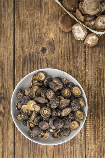 Dried Shiitake on a vintage background as detailed close-up shot, selective focus