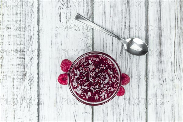 Fresh made Raspberry Jam on a vintage background as detailed close-up shot