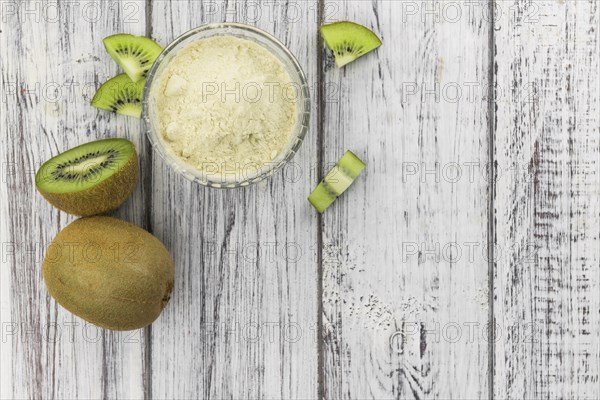 Fresh made Kiwi powder (slective focus, close-up shot) on an old wooden table