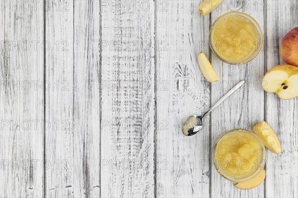 Portion of homemade Applesauce (selective focus, close-up shot) on vintage background
