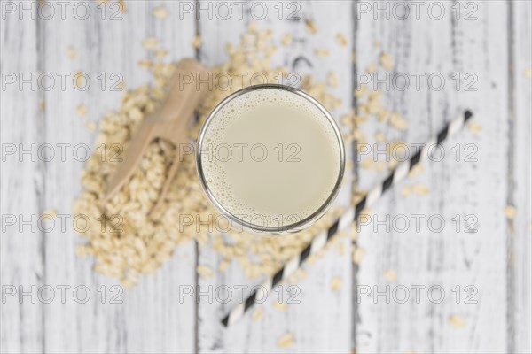Wooden table with Oat Milk (detailed close-up shot, selective focus)