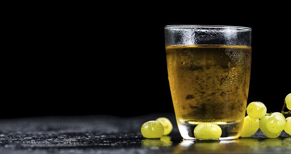 Some healthy Grape Juice on a vintage slate slab (selective focus)