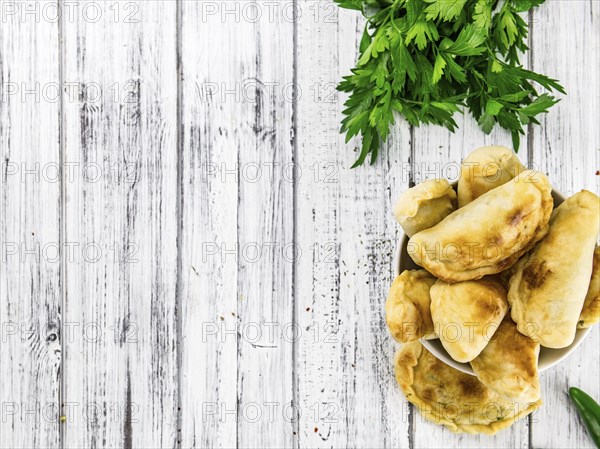 Portion of fresh homemade Empanadas as detailed close-up shot, selective focus