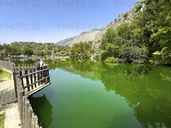 Tourist Holidaymaker standing on small viewing platform looking at artificial lake created in 1987
