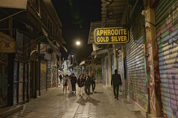 Strollers in an alley at night, closed shops, Monastiraki flea market, Athens, Greece, Europe