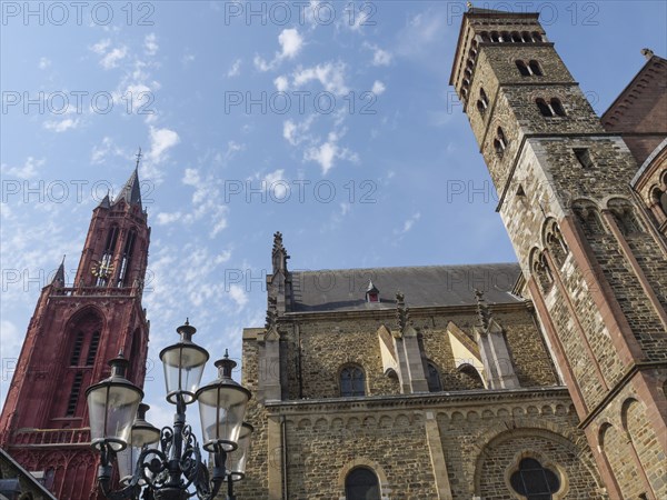 Church ensemble with Gothic towers and lanterns under a sunny sky, Maastricht, Limburg, Netherlands