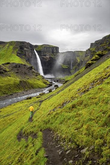 Hikers in a green canyon, Haifoss and Granni waterfall at a canyon, Fossá í Thjórsárdal, with river