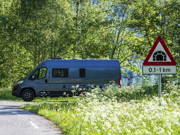 Camper van parked at the Sognefjord, road tunnel sign, Norway, Europe
