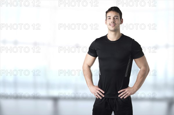 Personal Trainer With Hands on Waist in a Gym