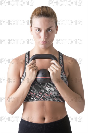 Fit woman working out with a kettlebel and similingl, isolated in white