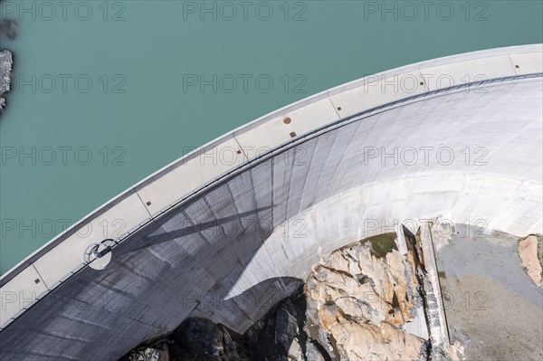 Aerial view of reservoir dam Barrage du Vieux Emosson and mountain hut Cabane Vieux Emosson,