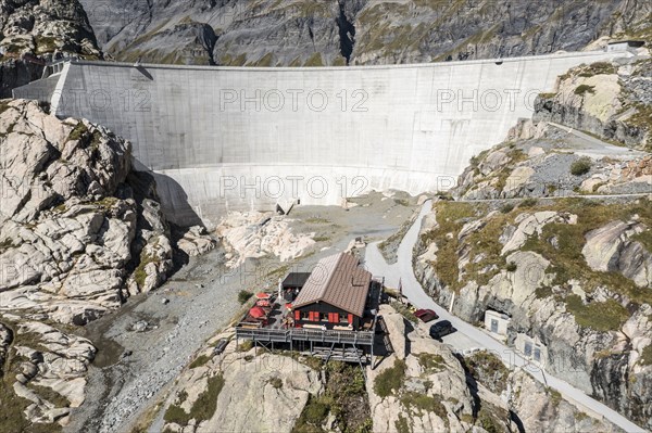 Aerial view of reservoir dam Barrage du Vieux Emosson and mountain hut Cabane Vieux Emosson,