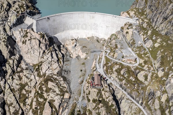 Aerial view of reservoir dam Barrage du Vieux Emosson and mountain hut Cabane Vieux Emosson,