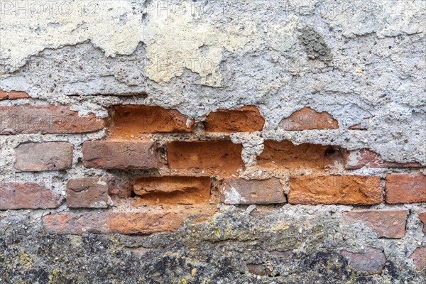 Old wall with crumbling plaster