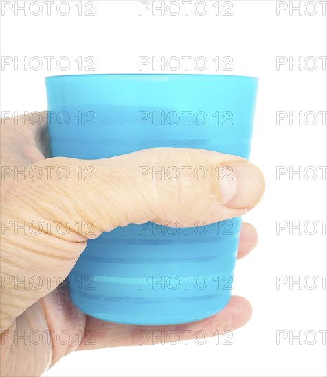 Empty blue plastic glass, held in a male persons hand