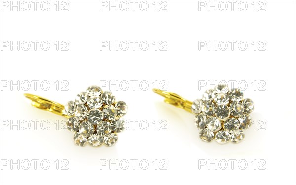 Diamond earrings on yellow gold, isolated towards white background