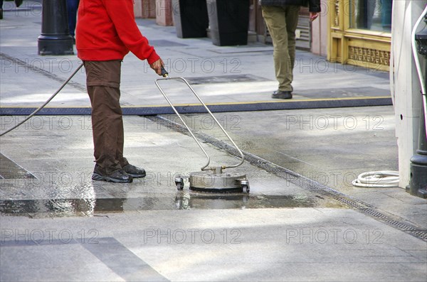Road sweeper cleaning granite stone floor