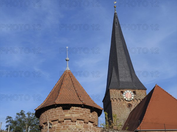 Gothic church with high tower and clock, red roof and blue sky, Kandel, Palatinate, Germany, Europe