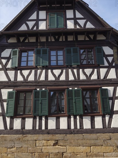 Traditional half-timbered house with green shutters and wooden structure, Kandel, Palatinate,