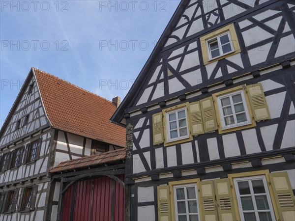 Traditional half-timbered houses with red roofs and shutters in a sunny daytime atmosphere, Kandel,