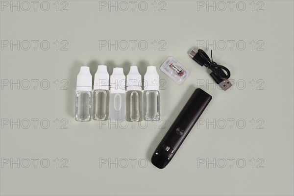 Bottles with liquid solutions for electronic cigarettes and charger