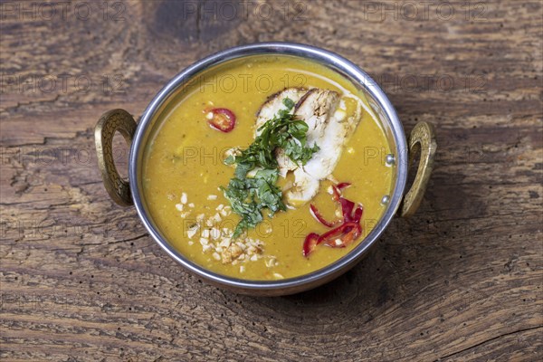 Indian mulligatawny soup in a brass bowl