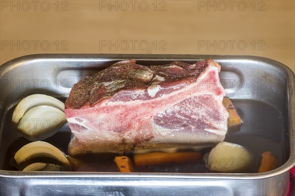 Raw pork shoulder in a casserole