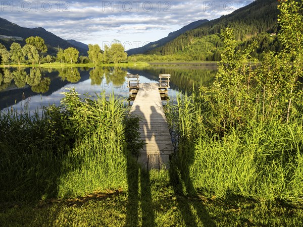 Shadow of a couple on a jetty, Gaishorner See in the evening light, Gaishorn am See, Paltental,