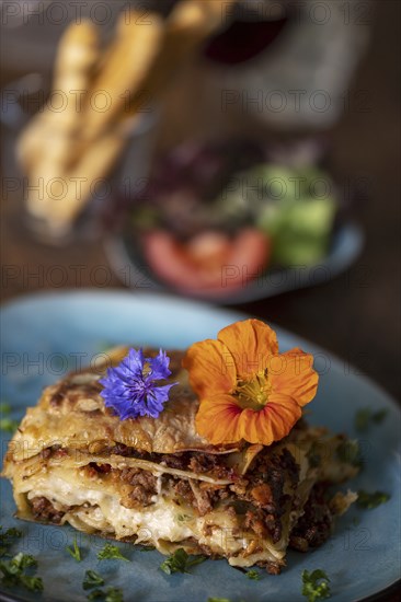 Fresh lasagne on a blue plate