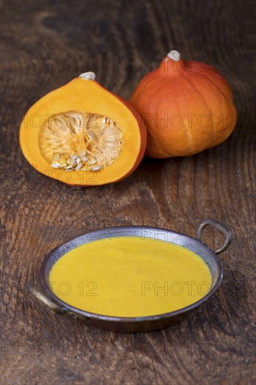 Close-up of pumpkin soup on wood