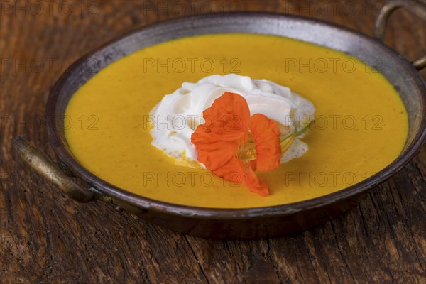 Close-up of pumpkin soup on wood