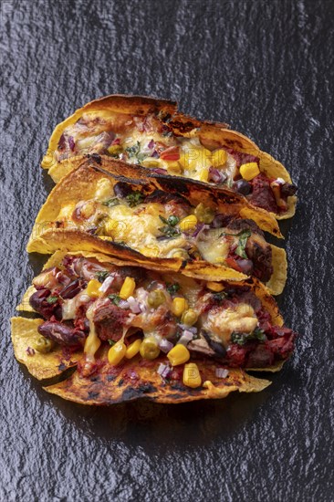 Gratinated tacos on slate