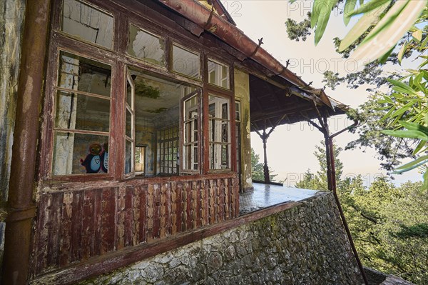 Dilapidated cottage with broken windows and views of the surrounding nature, Mussolini Villa, Villa