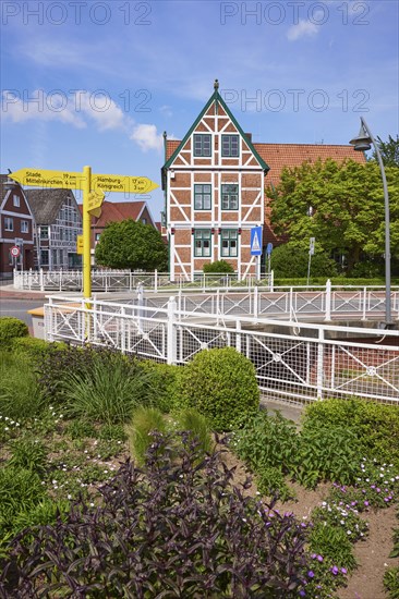 Town hall, signpost and flower bed in Jork, Altes Land, district of Stade, Lower Saxony, Germany,