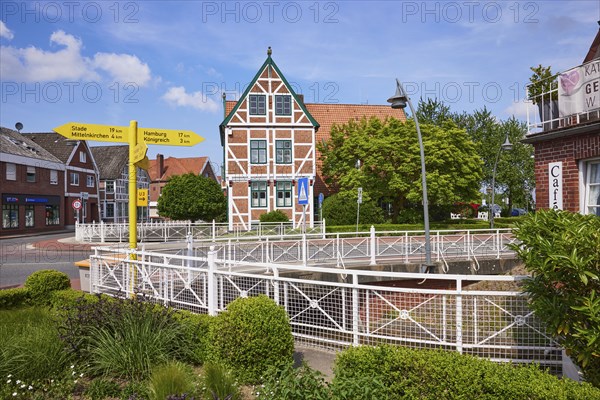 Town hall, signpost and flower bed in Jork, Altes Land, district of Stade, Lower Saxony, Germany,