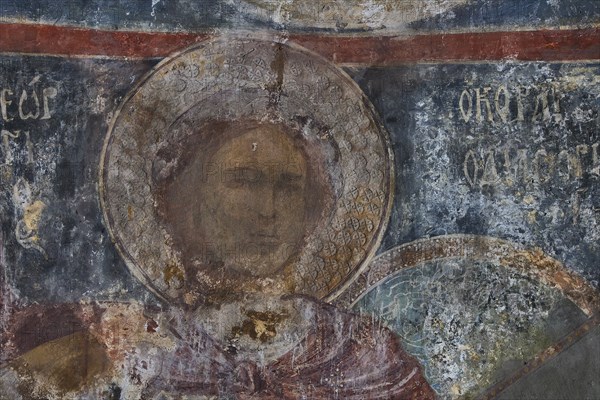 Close-up of a weathered mural in a church depicting a sacred figure, Byzantine Chapel of Agios