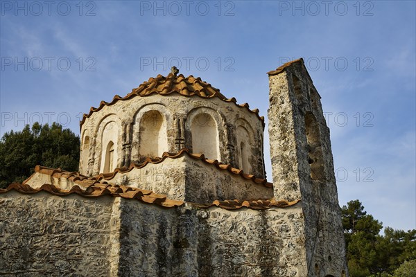 Close-up of an old church building with round windows and red bricks, Byzantine chapel Agios
